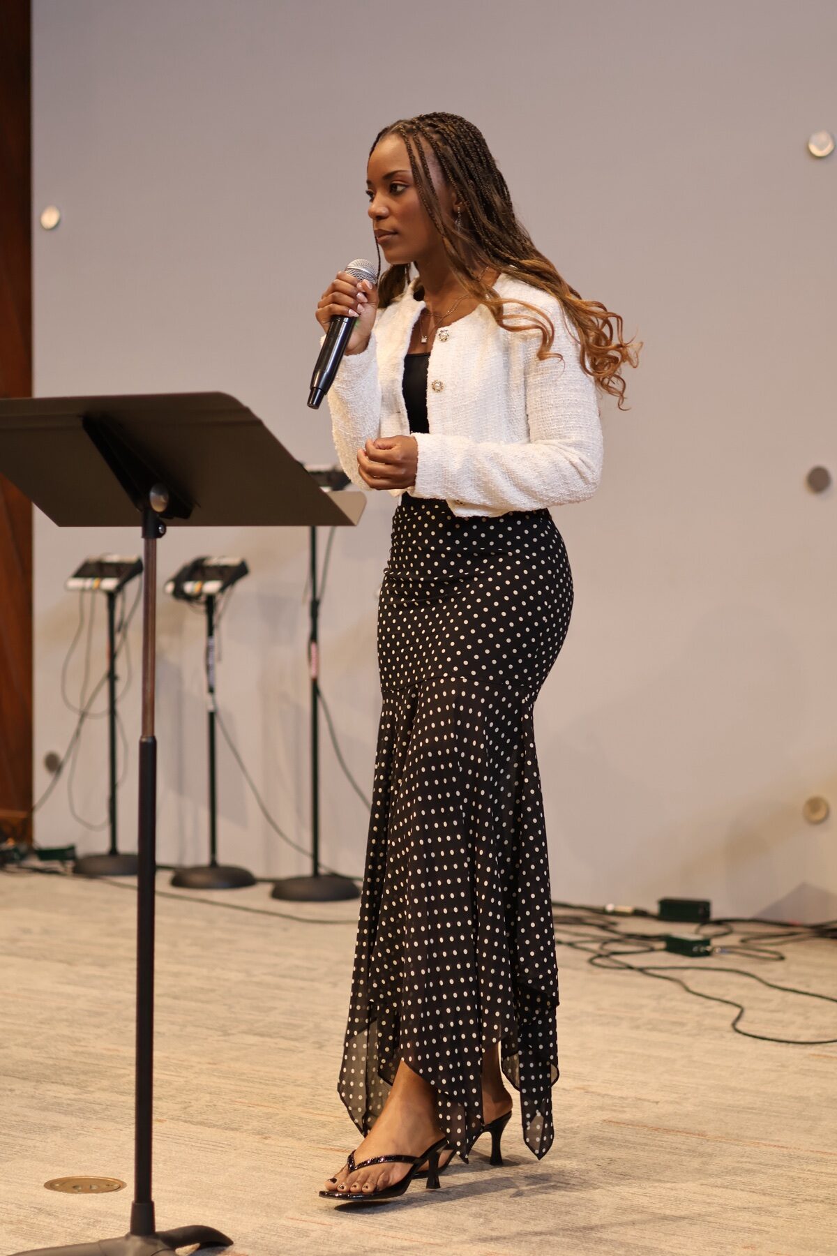 Woman leading the congregation at Valley of Oaks Church