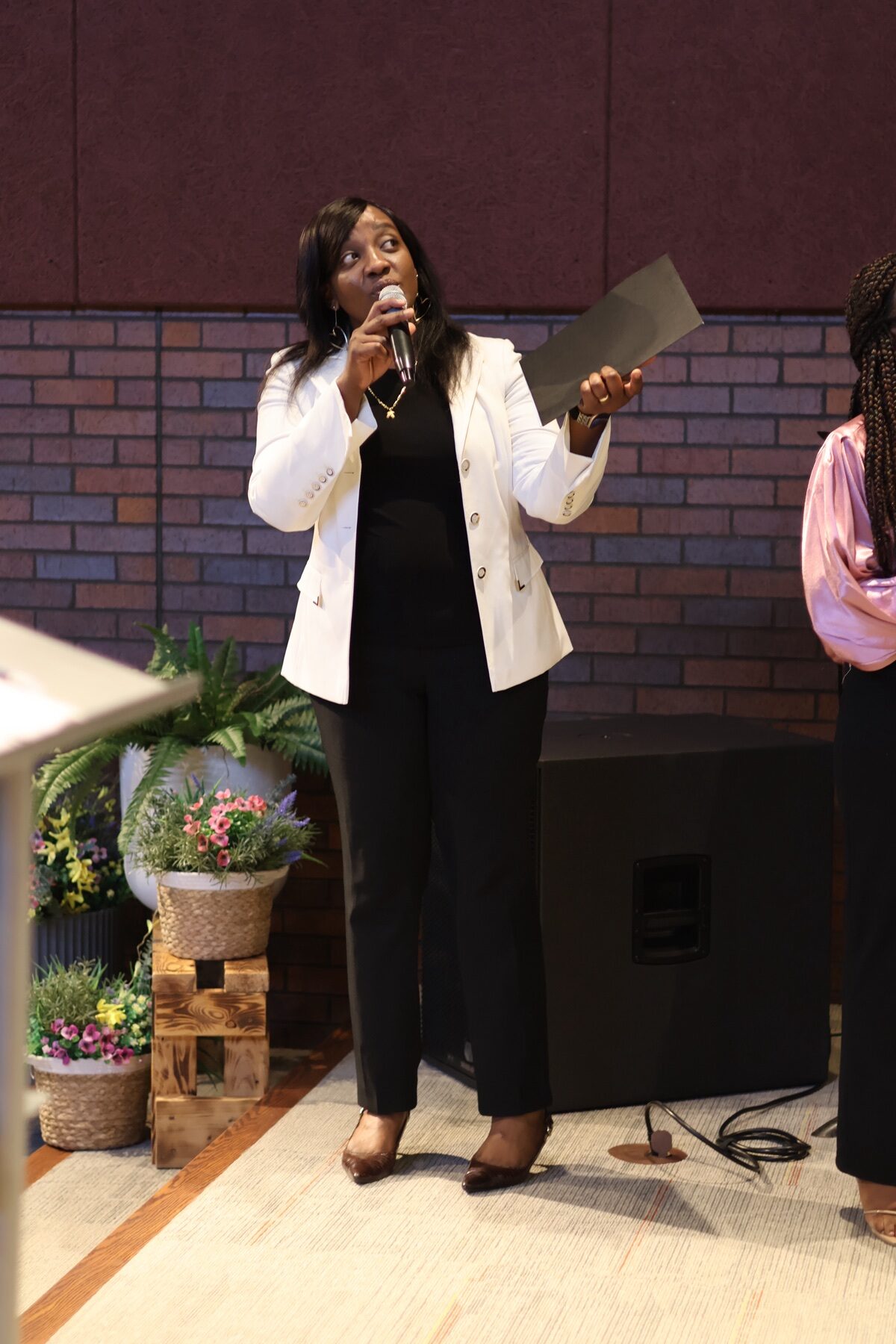 Woman addressing the congregation at Valley of Oaks Church