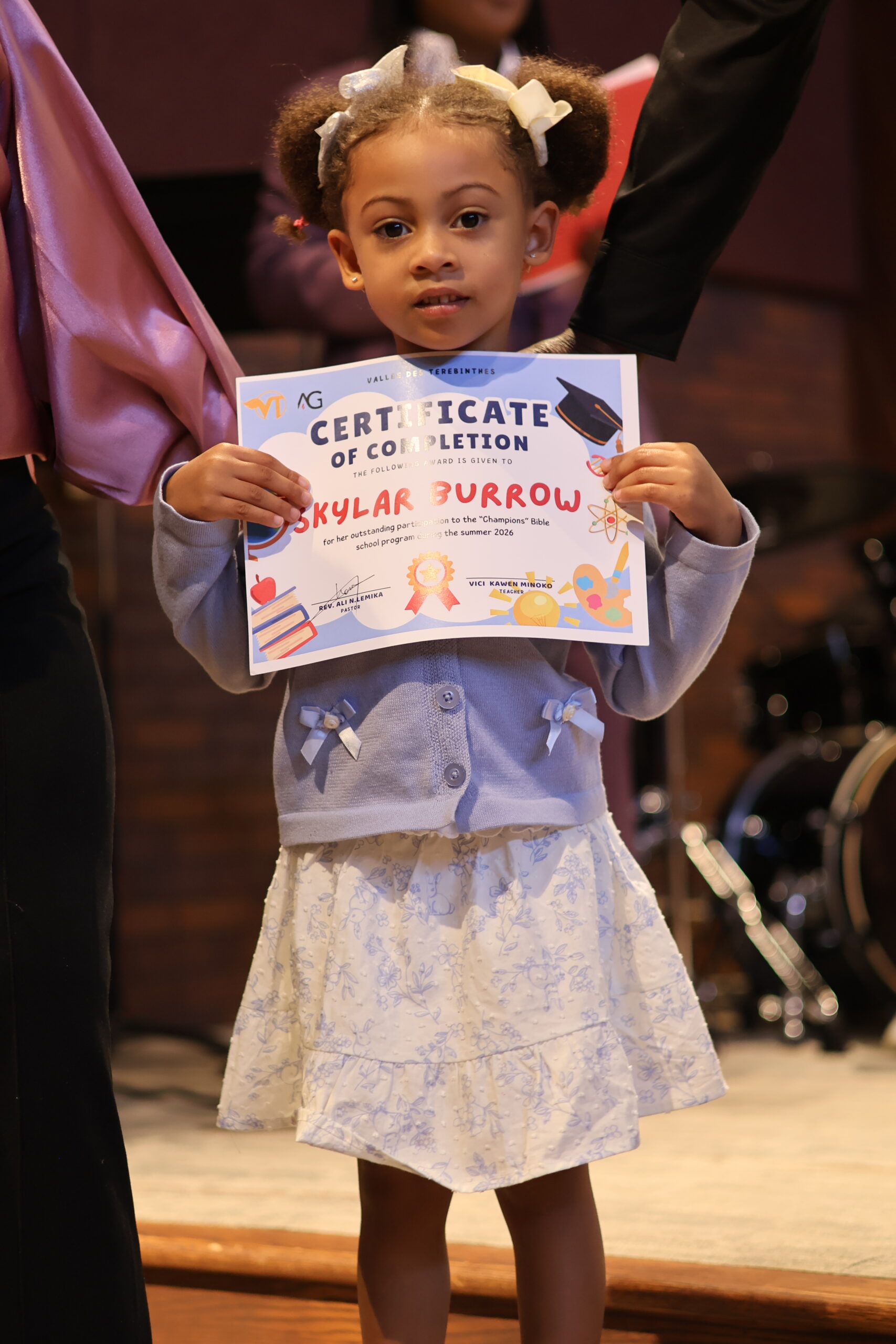 A young child celebrating completion of church summer school