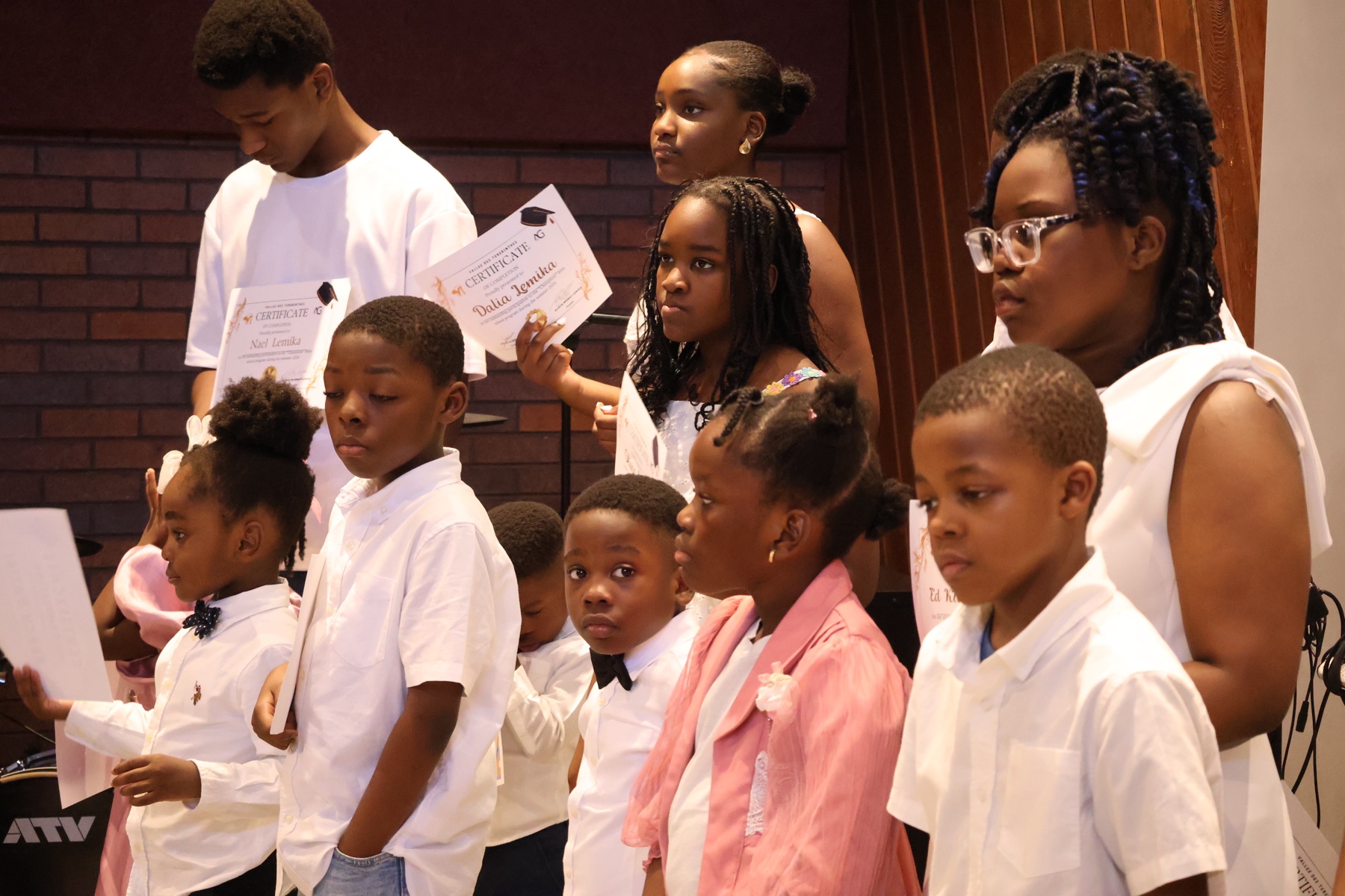 Children holding achievement certificates at Valley of Oaks Church