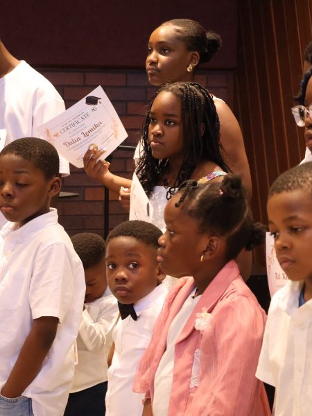 Children holding achievement certificates at Valley of Oaks Church